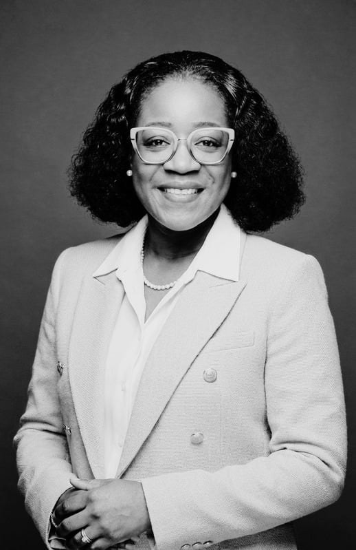 Black and white portrait of Priscillar Banda McMillan in a light blazer